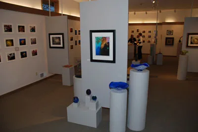 Framed underwater photographs on the gallery walls of the Riverfront Arts Center exhibit